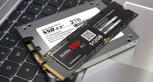 Different types of SSD disk drive isolated on laptop keyboard. C SSD Solid State Drive